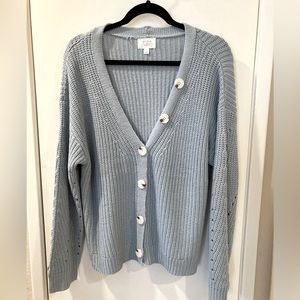 Light blue cardigan sweater.